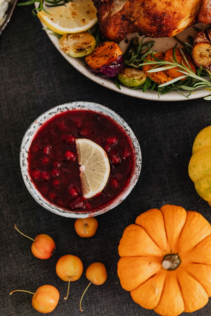 Autumnal still life with cranberry sauce, pumpkins, and seasonal vegetables for a festive meal.